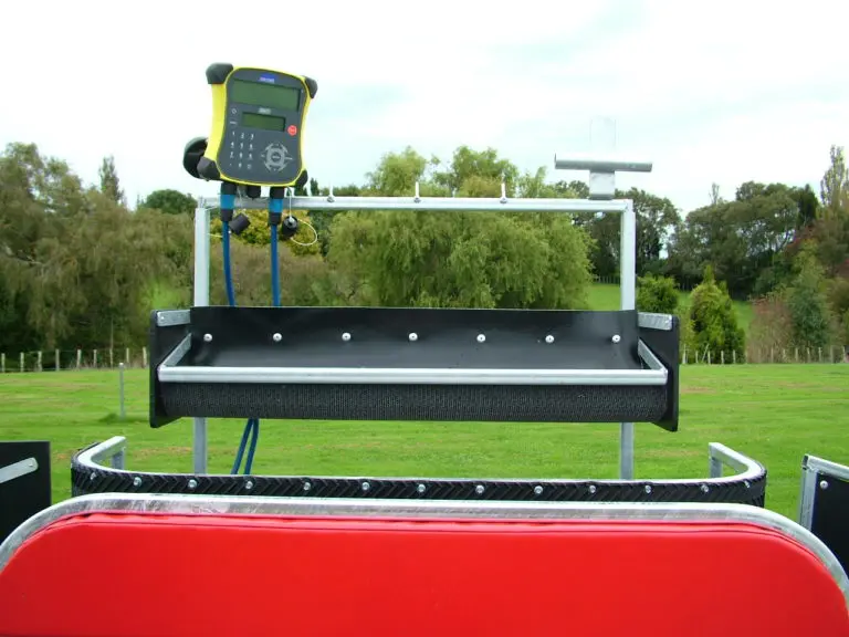 A tray holding veterinary supplies and farm tools