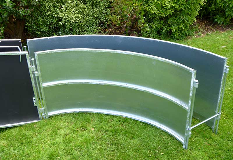 Curved metal livestock races in a yard